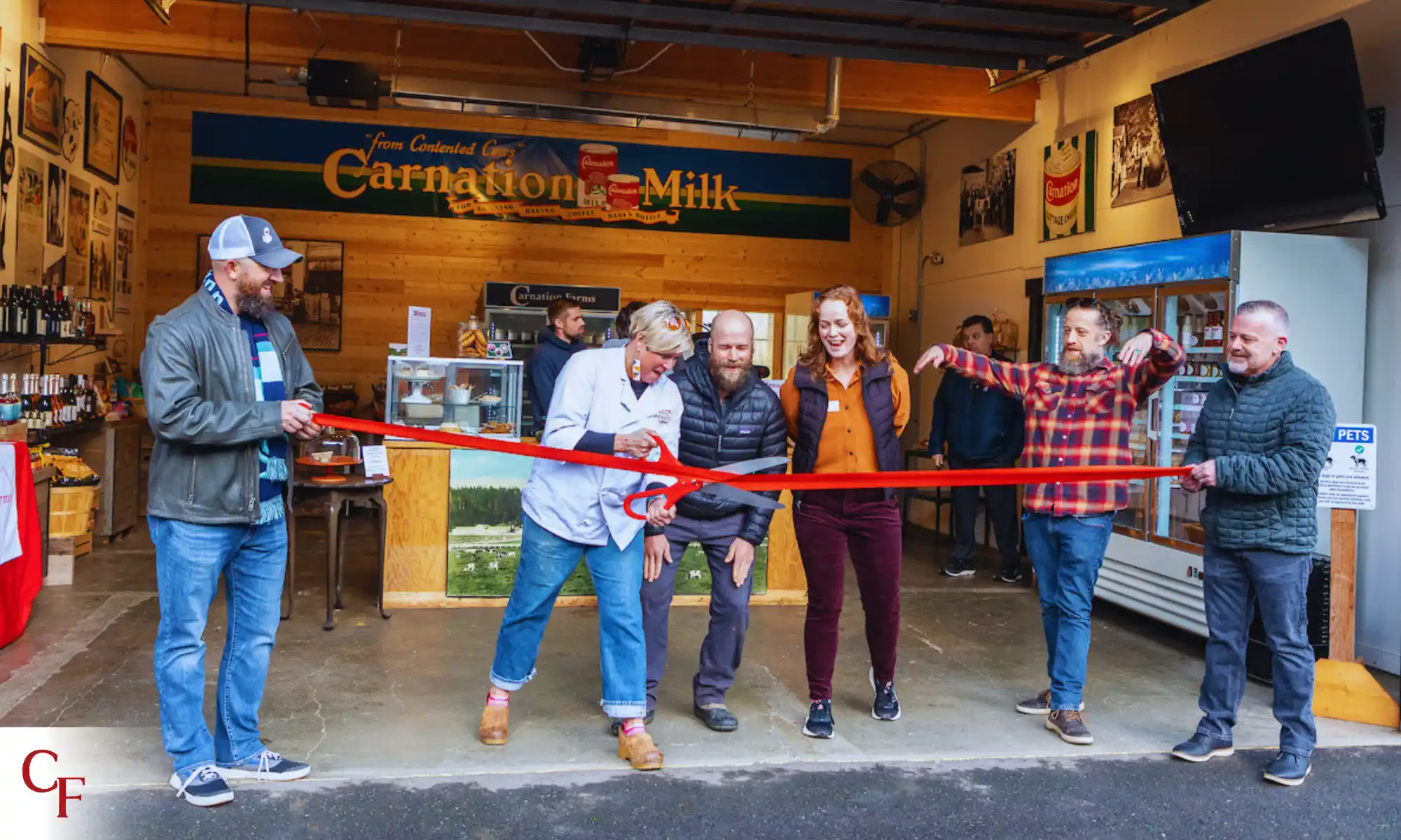 Community ribbon-cutting event inside a historic Carnation Farms building.