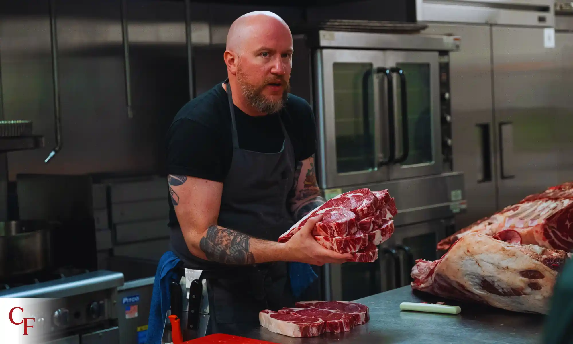 Chef preparing pasture-raised meat cuts in a farm kitchen